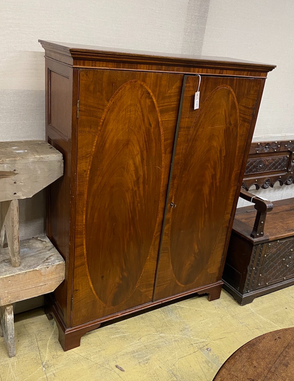 A George III mahogany side cabinet with pigeonhole interior, (altered) width 102cm, depth 34cm, height 137cm